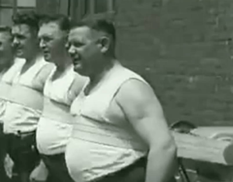 a-group-of-men-use-the-mueller-belt-in-this-screenshot-taken-from-1930s-footage-the-vibrating-contr