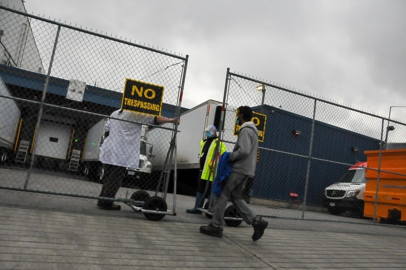 an-employee-enters-a-coquitlam-poultry-factory-on-lockdown-thursday