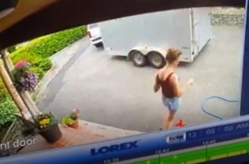 A woman delivering flyers is seen on a surveillance camera in Burnaby.
Contributed