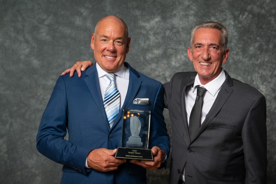 Andrew Tidman (left), Tidman Construction, is presented with the Lifetime Achievement Award by 2022 CARE Awards chair/VRBA president Norm Verbrugge (right). 