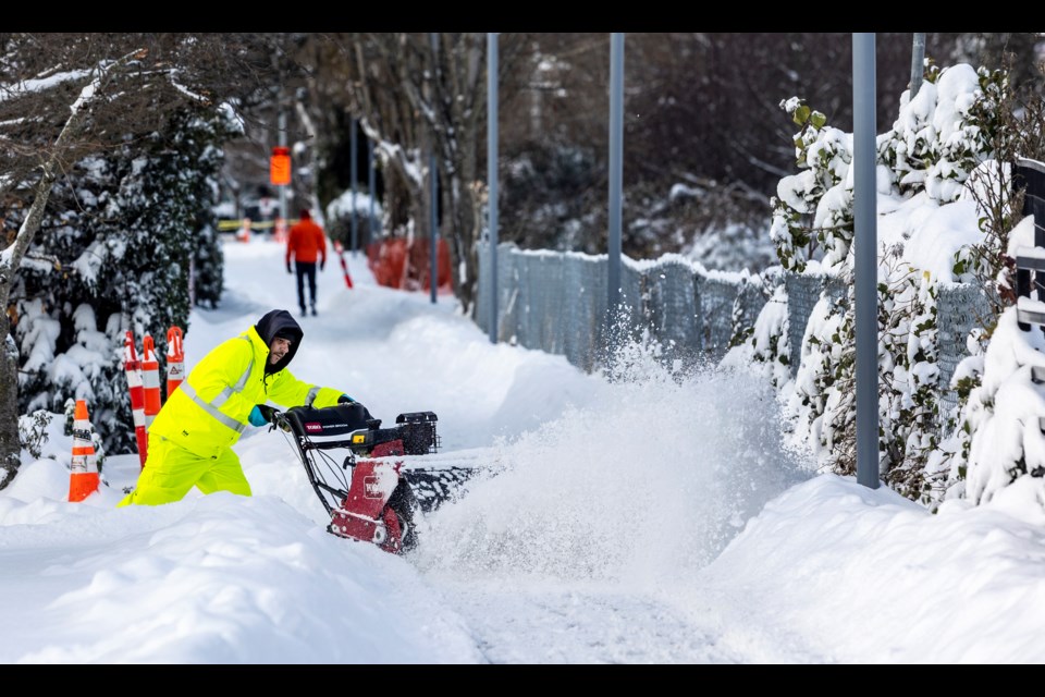 City of Victoria worker Ed Ribeiro clears snow near the Johnson Street Bridge on Tuesday, Dec. 20, 2022. Temperatures are forecast to be below freezing until Friday. DARREN STONE, TIMES COLONIST 
