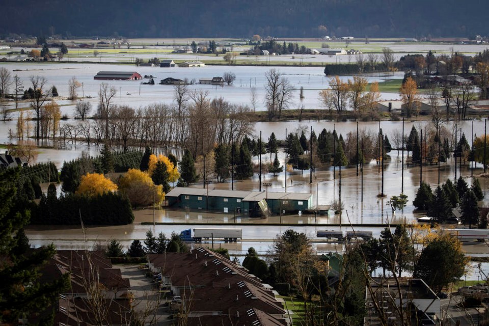 Abandoned transport trucks are seen on the Trans-Canada Highway in a flooded area of Abbotsford on Tuesday, Nov. 16, 2021. (Darryl Dyck/The Canadian Press)