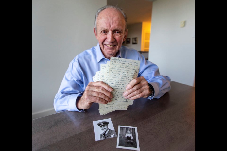 Brian Josling, 79, with a photo of his father, Tom Walmsley, and himself as a two-year-old, along with a letter that his father wrote him for his second birthday in 1944, just days before Tom died in a training flight. DARREN STONE, TIMES COLONIST