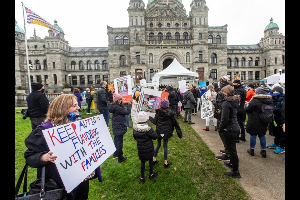 Opponents to a plan to shift autism treatment funding away from individual families rally at the legislature on Wednesday, Nov. 24, 2021. Current funding is $22,000 for children six and under, and $6,000 for older children. DARREN STONE, TIMES COLONIST 