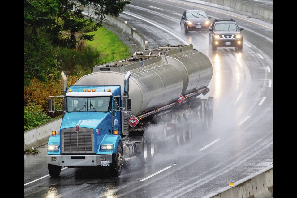 Shelves are full at the Market on Yates on Thursday. A gasoline tanker passes under the Leigh Road overpass on Thursday, en route to refilling Greater Victoria gas stations.  PHOTOS BY DARREN STONE, TIMES COLONIST 