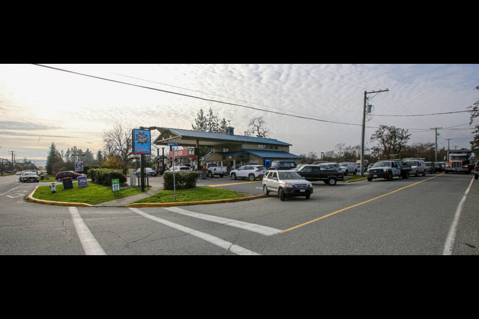 People line up for gas at the Peninsula Co-op station at the corner of West Saanich Road and Birch Road on Wednesday. ADRIAN LAM, TIMES COLONIST 