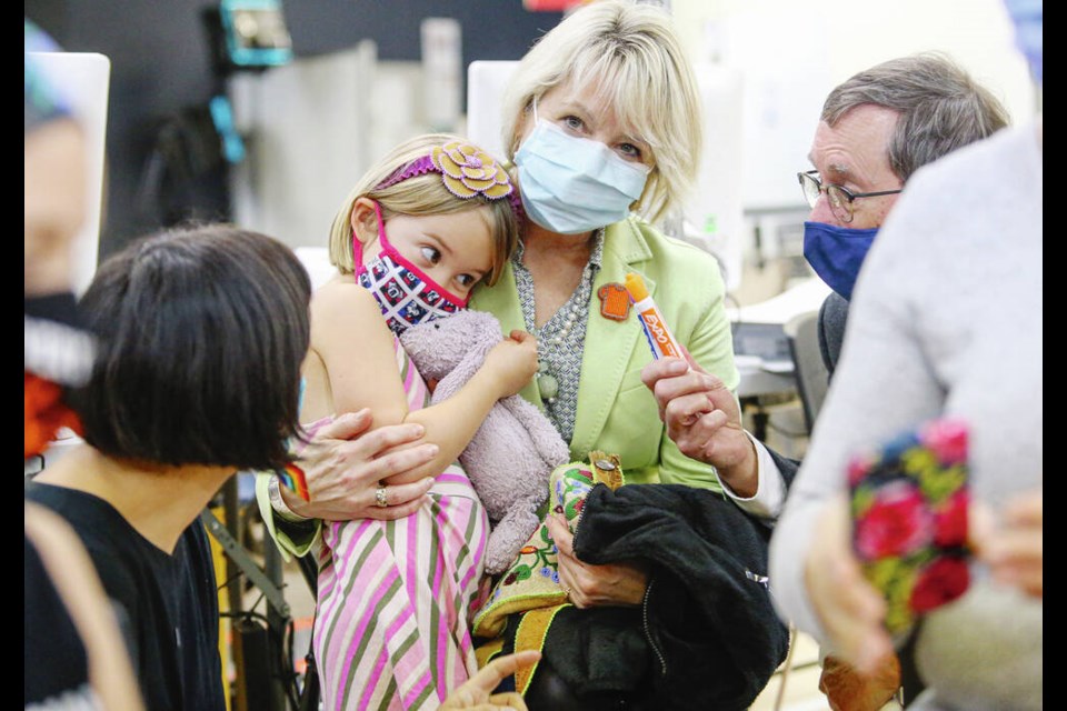Bonnie Henry holds Maeve Fletcher, 5, before her shot at University Heights Mall on the first day of COVID-19 vaccinations for children ages 5 to 11. ADRIAN LAM, TIMES COLONIST 
