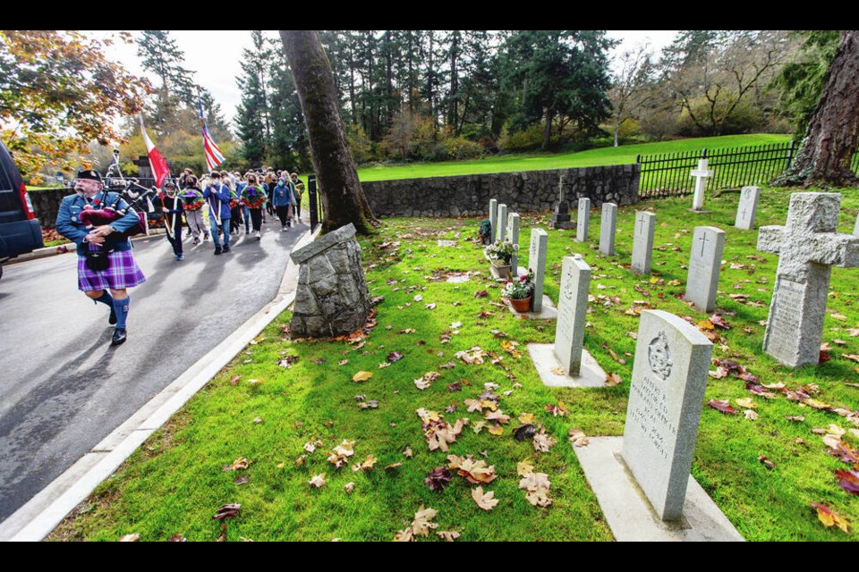Rockheights Middle School students are piped in during No Stone Left Alone ceremonies at God's Acre Cemetery in Esquimalt on Friday. DARREN STONE, TIMES COLONIST 
