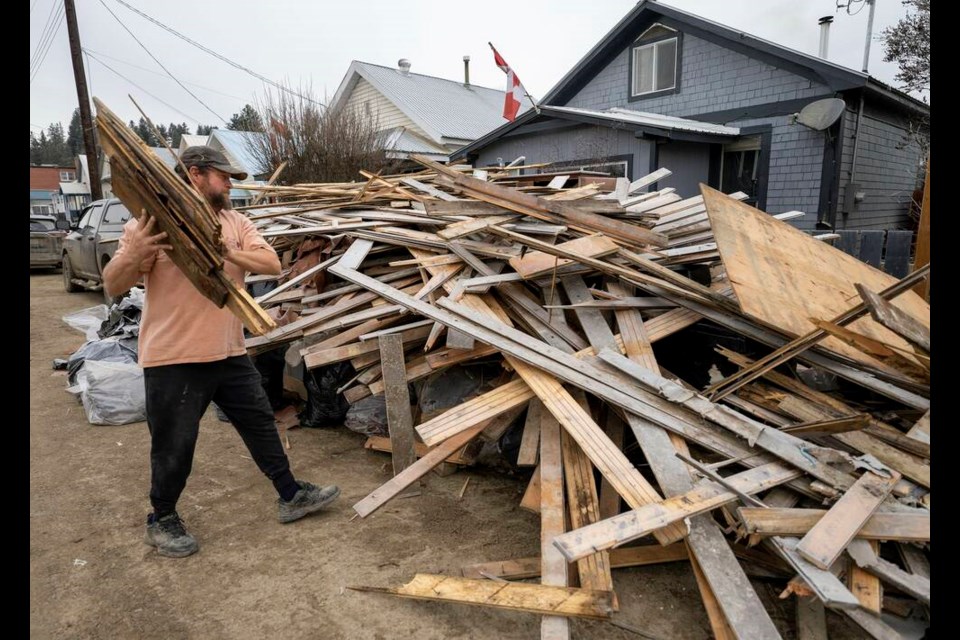 A man helps clear out a home in downtown Princeton, B.C., Friday, Dec. 3, 2021. Princeton, like many parts of the province, was hit with heavy floods and mudslides over the past couple of weeks causing major devastation. THE CANADIAN PRESS/Jonathan Hayward