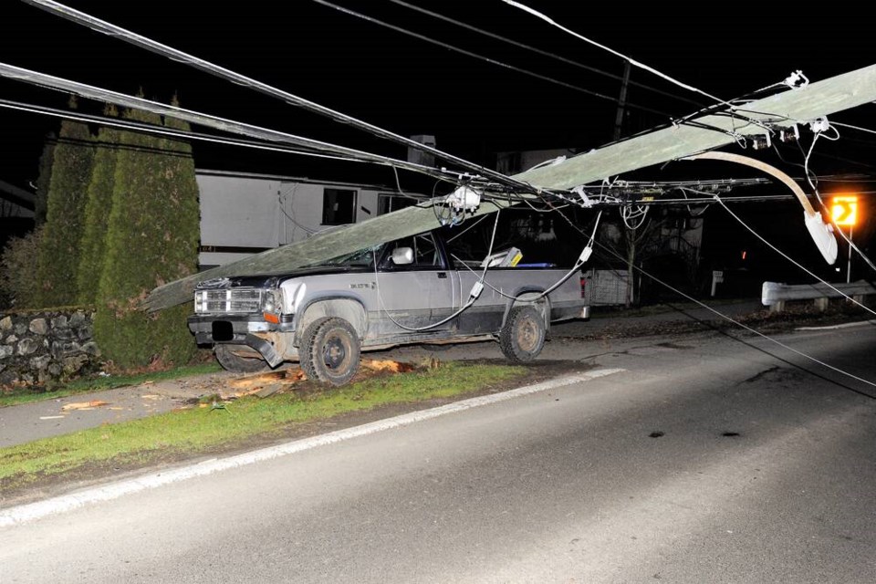 The base of a utility pole was sheared off when it was struck by a pickup on Burnside Road West on Sunday, Jan. 23, 2022. The driver was trapped inside by the active wires but did not appear to be seriously injured, Saanich police said. SAANICH POLICE DEPARTMENT
