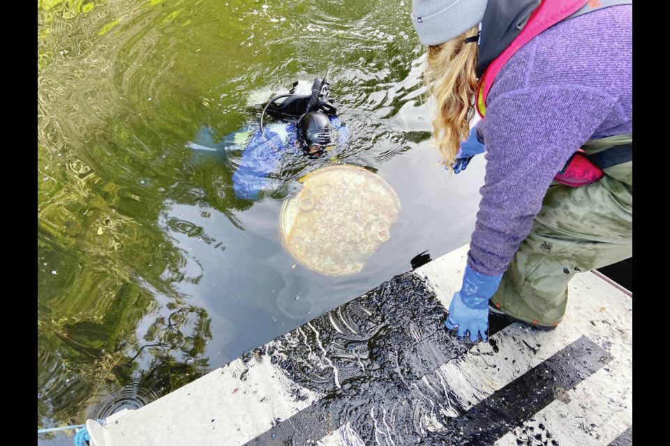 An old drum is pulled from the depths near Tofino. COASTAL RESTORATION SOCIETY 