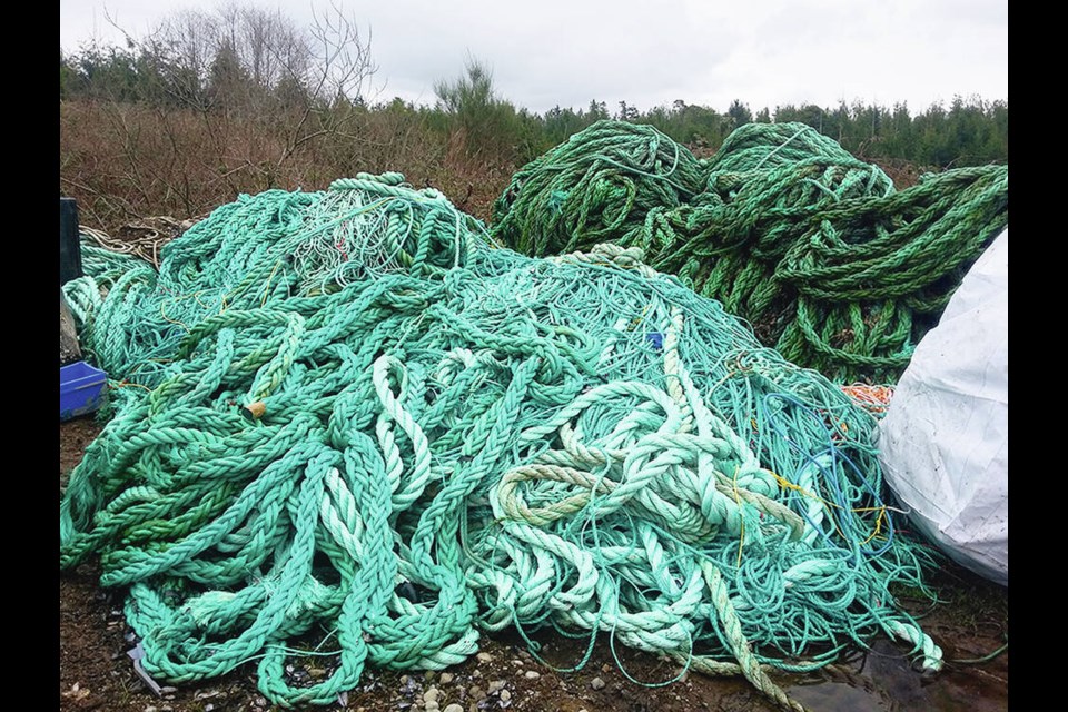 Piles of rope collected from the west coast of the Island are hauled ashore and ready for shipment to Steveston, where it will be recycled. DFO PHOTO 