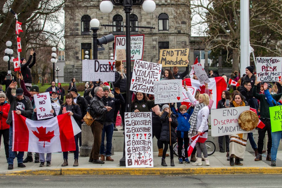People line Belleville Street in front of the B.C. legislature on Saturday to protest pandemic restrictions. DARREN STONE, TIMES COLONIST. Jan. 29, 2022 