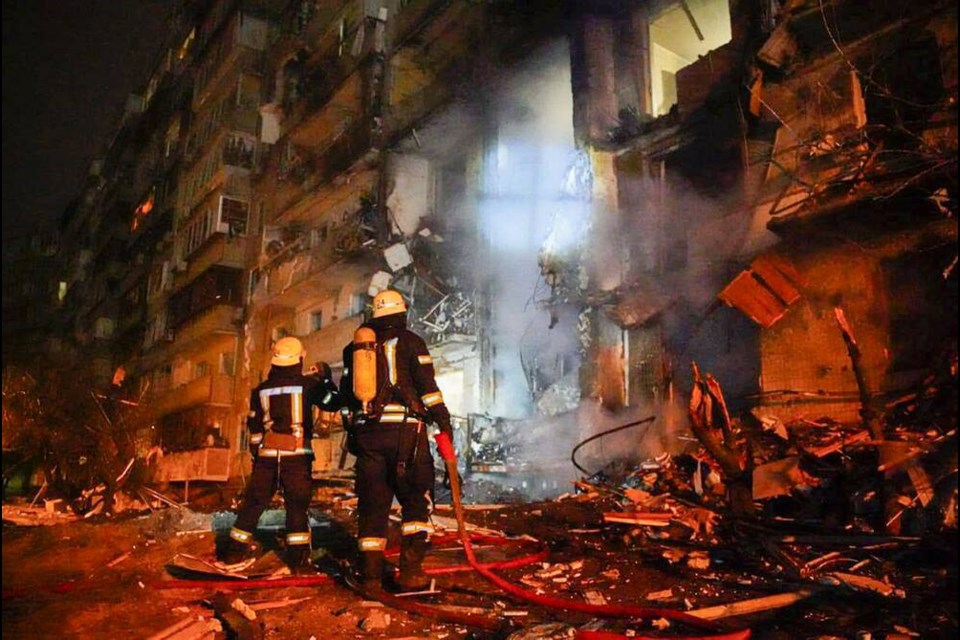 In this handout photo taken from video released by Ukrainian Police Department Press Service released on Friday, Feb. 25, 2022, firefighters inspect the damage at a building following a rocket attack on the city of Kyiv, Ukraine, Friday, Feb. 25, 2022. Russia is pressing its invasion of Ukraine to the outskirts of the capital. That comes a day after it unleashed airstrikes on cities and military bases and sent in troops and tanks from three sides. (Ukrainian Police Department Press Service via AP)