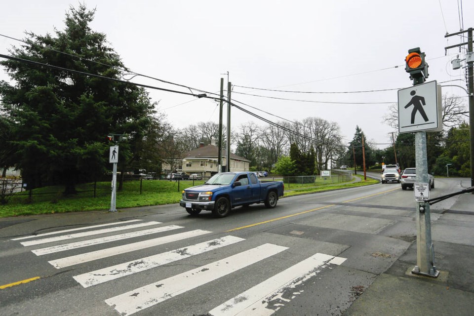 Improvements to the crosswalk at Cedar Hill Cross Road and Merriman Drive coming this week include a new street light over top of the crosswalk and rectangular rapid-flashing beacons to replace round flashing beacons. ADRIAN LAM, TIMES COLONIST 