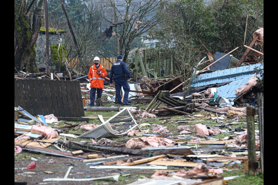 Crews at the scene where a one-storey home exploded on Pine Street in Nanaimo on Sunday evening. The house was at the corner of Pine and Fitzwilliam streets, adjacent to the cemetery at St. Peters Roman Catholic Church in Nanaimo. ADRIAN LAM, TIMES COLONIST 