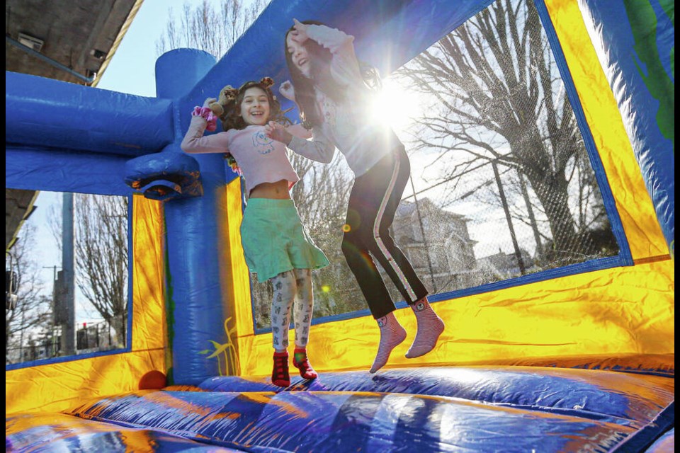 Cielo Sandoval-Asch, 7, and Elsa McDonald, 7, right, have some fun during Family Day celebrations at Royal Athletic Park in Victoria. ADRIAN LAM, TIMES COLONIST. Feb. 21, 2022 