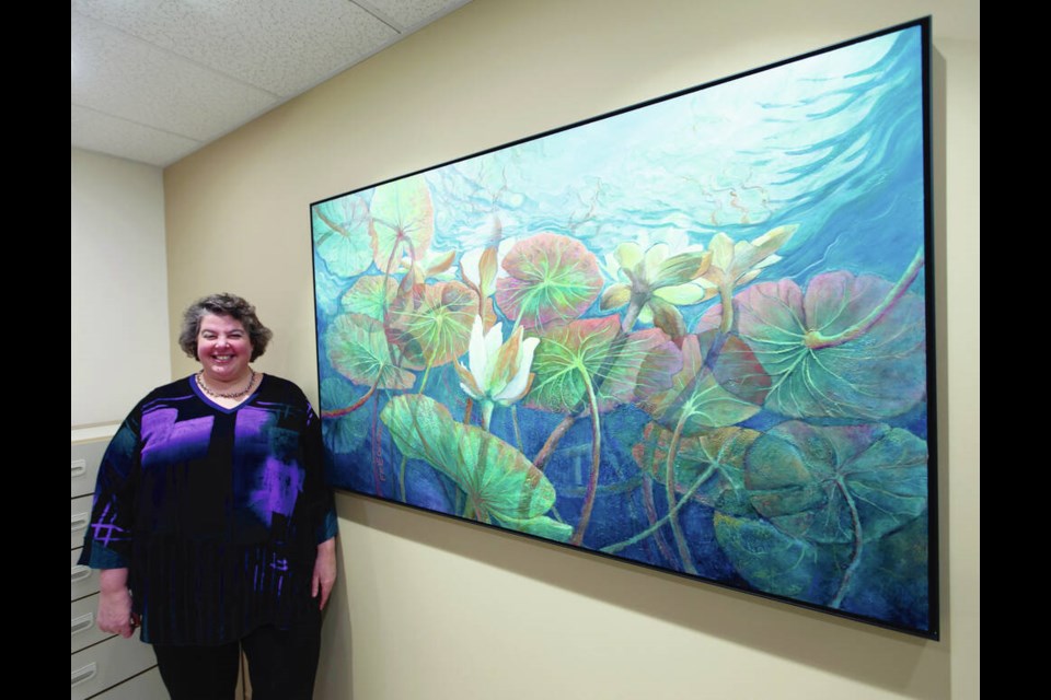 Lesley Friedmann, one of the contributors to A Work of Heart, an online art tour and auction, with her painting Lotus and Water Lilies. DARREN STONE, TIMES COLONIST 