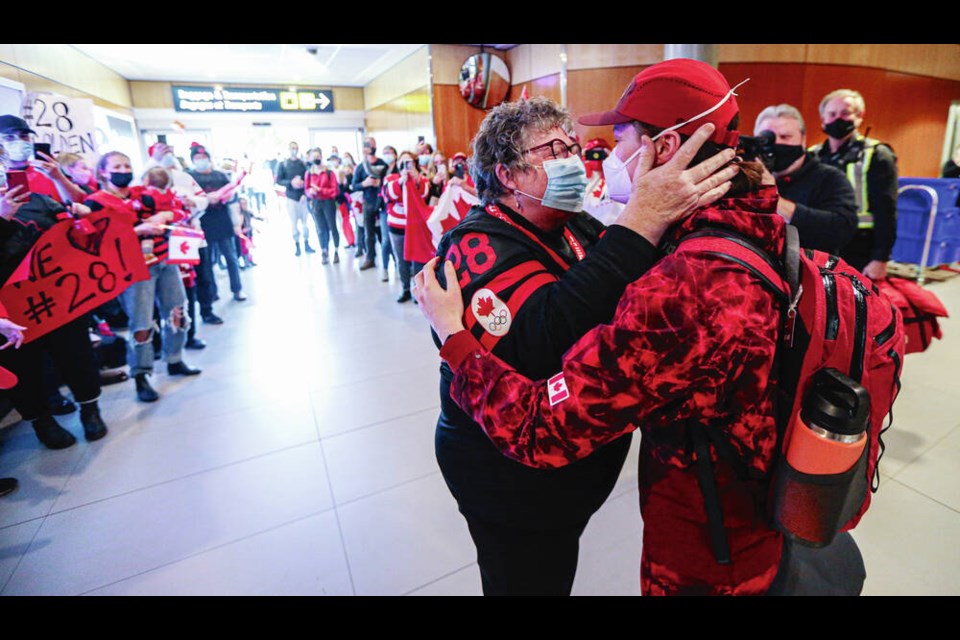 Pat Zander-Hart greets her daughter, Canadian hockey player Micah Zandee-Hart, as Micah returns with her Olympic gold medal at Victoria International Airport. ADRIAN LAM, TIMES COLONIST 
