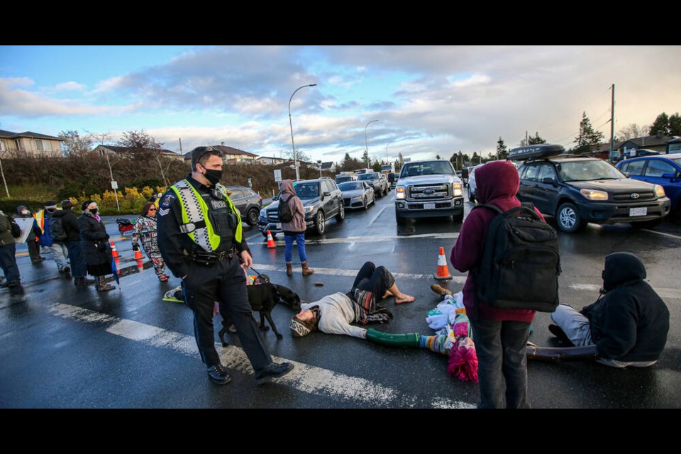 Saanich police and West Shore RCMP warn and arrest protesters who blocked northbound Trans-Canada at Tillicum during Tuesday afternoon rush hour. ADRIAN LAM, TIMES COLONIST Jan. 31, 2022 