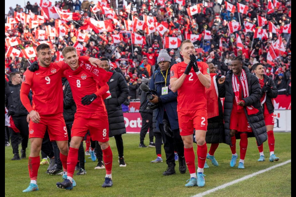 Members of Canada's national soccer team celebrate after clinching a berth in CONCACAF World Cup Qualifier soccer action against Jamaica in Toronto on Sunday March 27, 2022 THE CANADIAN PRESS/Frank Gunn