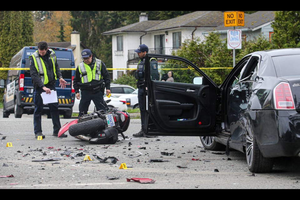 Saanich police investigate the scene of a crash involving a motorcycle and vehicle on McKenzie Avenue near Arlene Place, just west of Carey Road, on Tuesday morning. ADRIAN LAM, TIMES COLONIST 