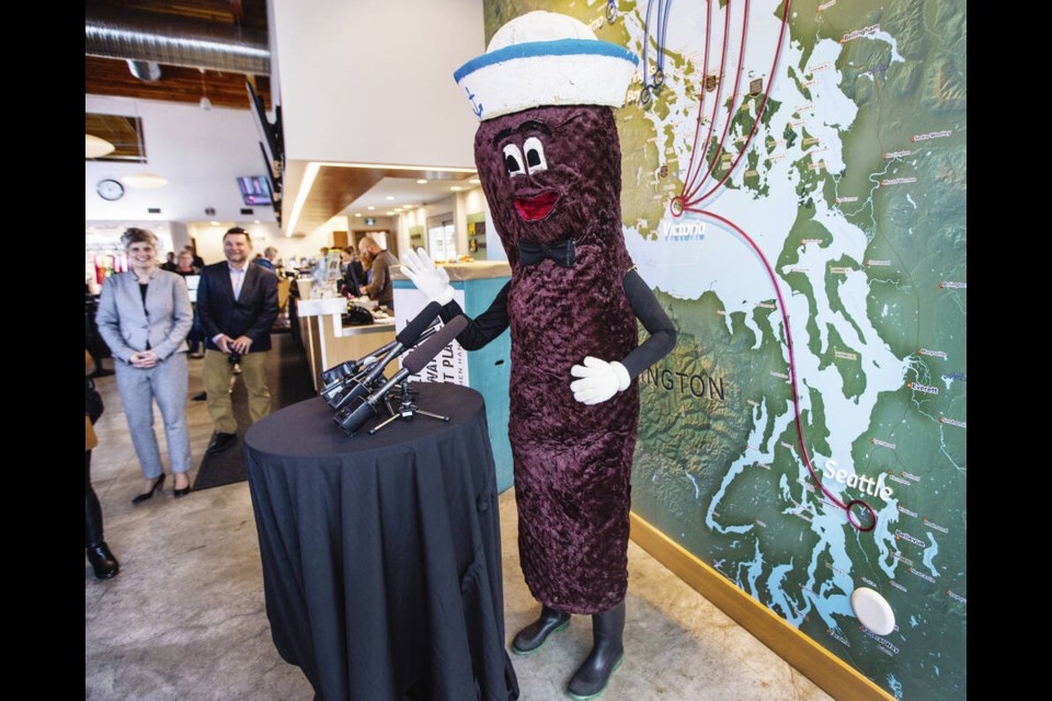 Mr. Floatie gives a news conference at the Victoria Seaplane Terminal before for a trip to Seattle in 2017. The Royal B.C. Museum acquired the costume, with its battery fan to keep Skwarok cool, shortly after. DARREN STONE, TIMES COLONIST 