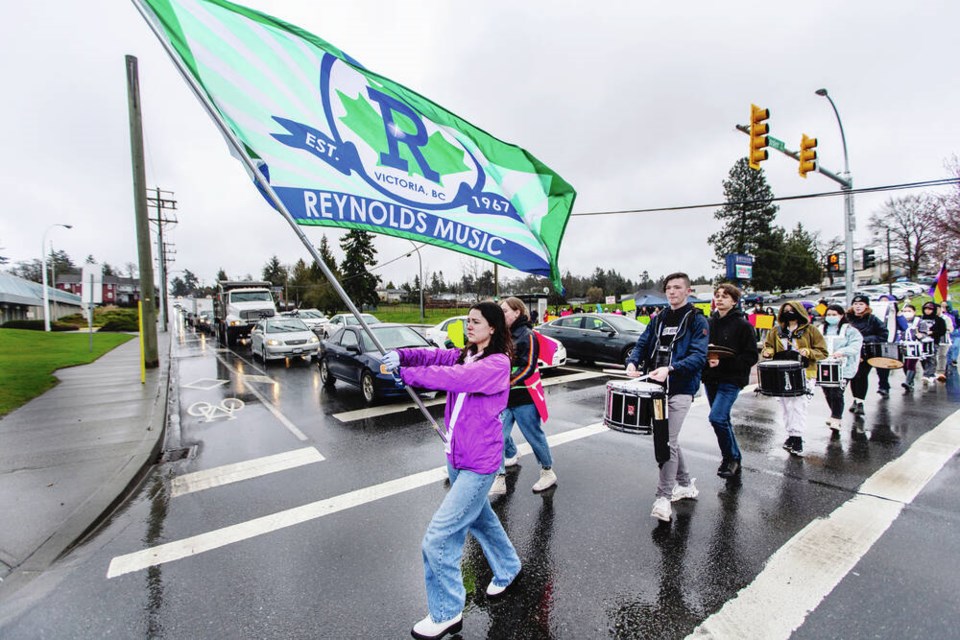 Members of the Reynolds Secondary School marching band cross McKenzie Avenue during a rally on Thursday against proposed cuts to music programs in the Greater Victoria School District. Story, page A3 DARREN STONE, TIMES COLONIST 