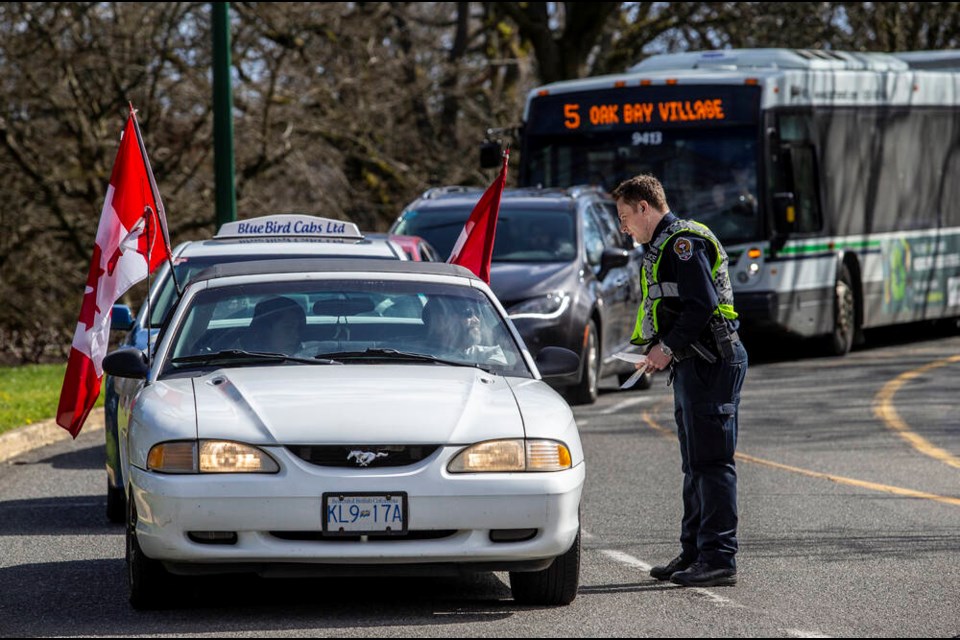Victoria police officers check vehicles at a roadblock on Superior Street near Douglas Street as police closed off James Bay to all but local traffic on Saturday, March 19, 2022, ahead of expected protests at the legislature. DARREN STONE, TIMES COLONIST