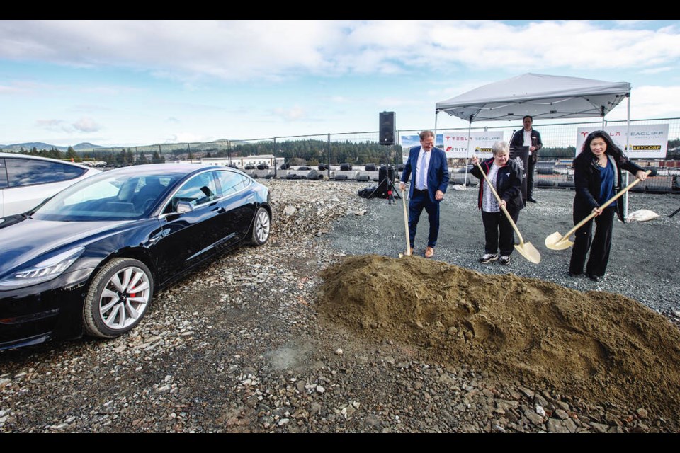 From left, Langford Mayor Stew Young, Tesla Owners Club VP Heather Kellingon and Jeany Lee, Seacliff Properties director for acquisitions and asset management, perform a ceremonial groundbreaking for the first Vancouver Island Tesla sales, service and delivery centre at City Gate Boulevard.  DARREN STONE, TIMES COLONIST 