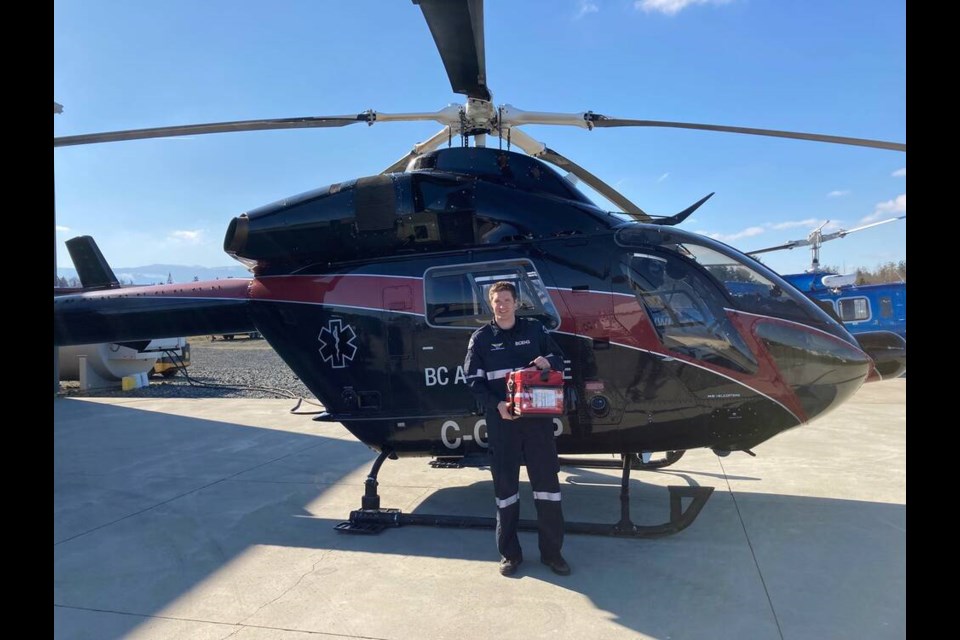 Critical care paramedic Brian Gill with a blood storage box in front of a B.C. Emergency Health Services helicopter. VIA BCEHS