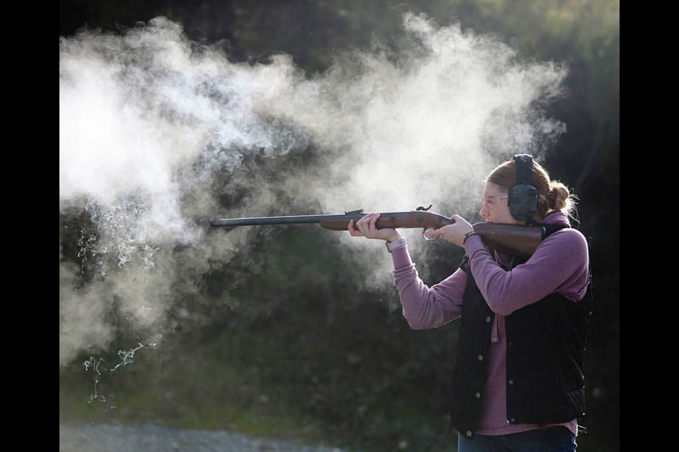 Bailey Drinkwalter is surrounded by white smoke after firing a ­percussion ­muzzleloader rifle at the ­Victoria Fish & Game ­Protective ­Association. Also known as a caplock, the rifle was an ­improvement on the ­original ­flintlock rifle and came about in the 19th century. ADRIAN LAM, TIMES COLONIST 