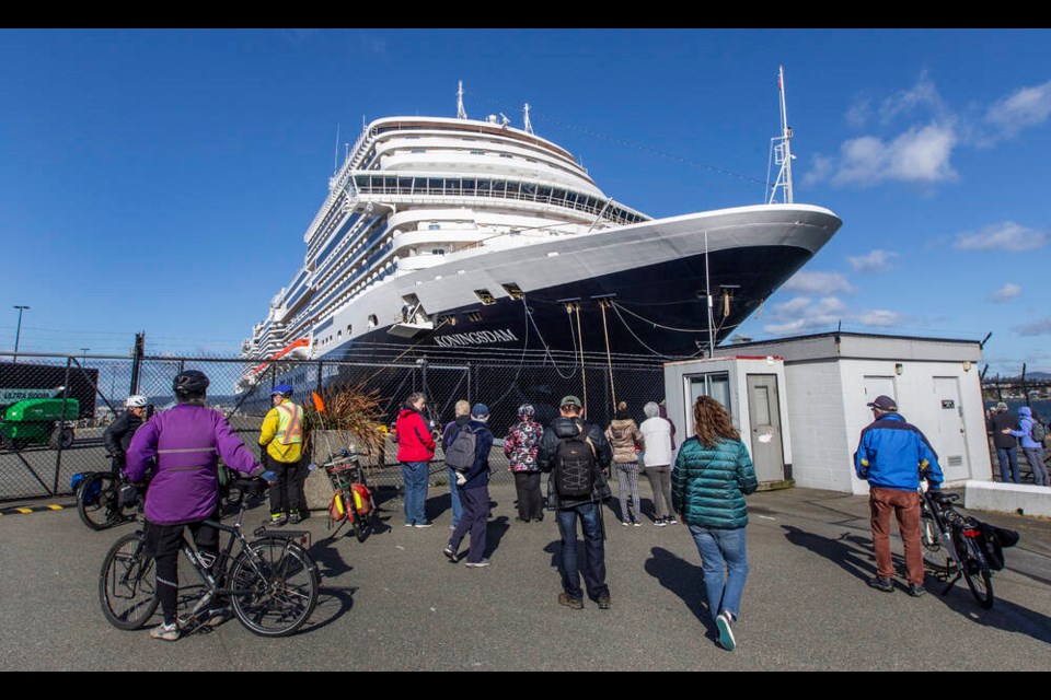 People watch from shore as the first cruise ship since 2019, MS Koningsdam, docks at Ogden Point terminal on Saturday. DARREN STONE, TIMES COLONIST