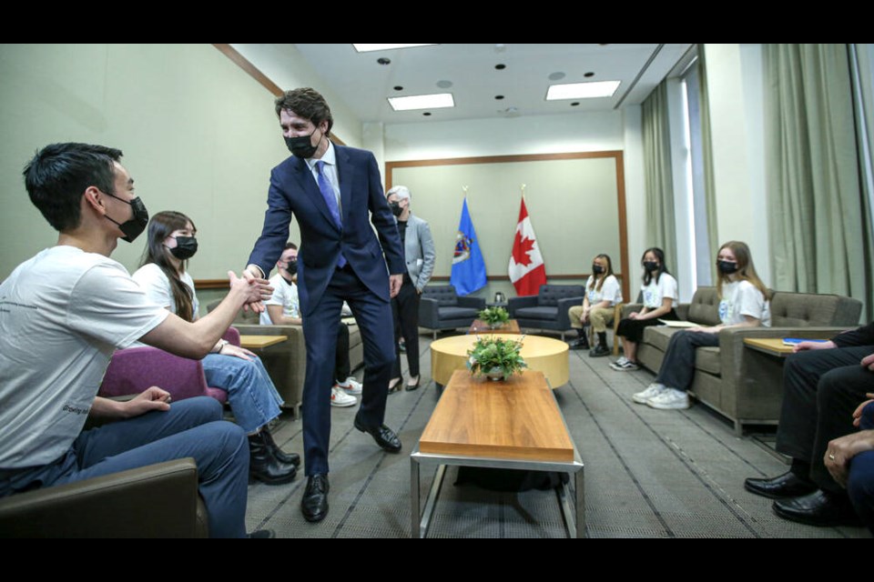 Sota Nakahara of Lambrick Park Secondary School, a member of the City of Victoria Youth Advisory Council, shakes hands with Prime Minister Justin Trudeau at Victoria City Hall on Monday. ADRIAN LAM, TIMES COLONIST 