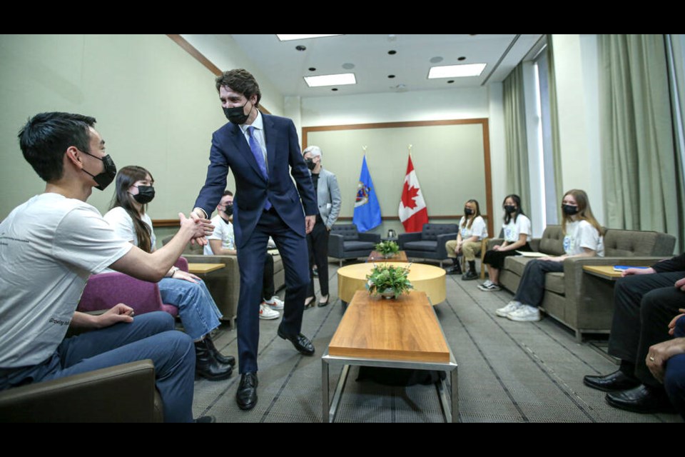 Sota Nakahara of Lambrick Park Secondary School, a member of the City of Victoria Youth Advisory Council, shakes hands with Prime Minister Justin Trudeau at Victoria City Hall on Monday. ADRIAN LAM, TIMES COLONIST 