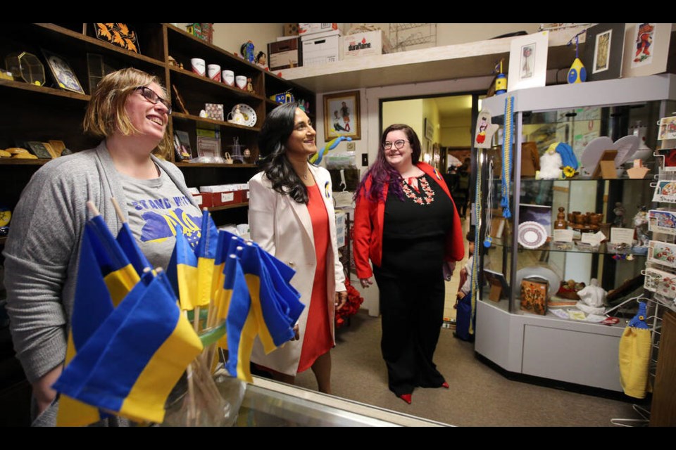 Victoria Grando, left, office manager at the Ukrainian Cultural Centre, and Devon Sereda Goldie, right, give Defence Minister Anita Anand a tour of the centres gift shop on Tuesday. ADRIAN LAM, TIMES COLONIST 