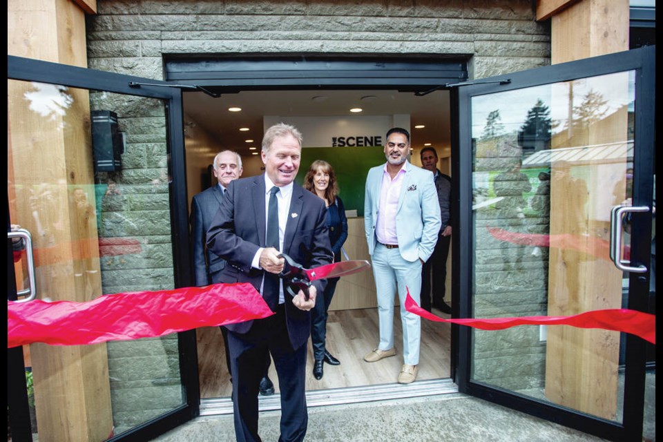 Langford Mayor Stew Young cuts the ribbon at the opening of The Scene's presentation centre on Peatt Road on Friday. Its two condo towers will be 18 and 24 storeys tall. 	DARREN STONE, TIMES COLONIST 