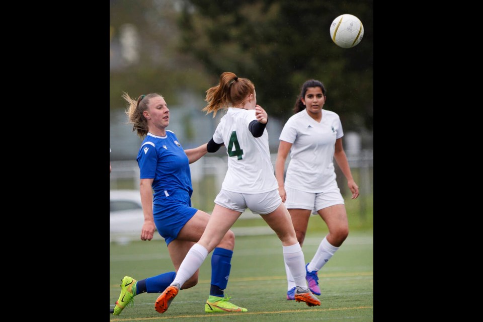 SMUS Blue Jags' Brianne MacLeish  kicks the ball past Glenlyon Norfolk School Gryphons' Faye Dryden in Ryan Cup quarter-final action at the University of Victoria turf soccer fields on Thursday, May  5, 2022. DARREN STONE, TIMES COLONIST