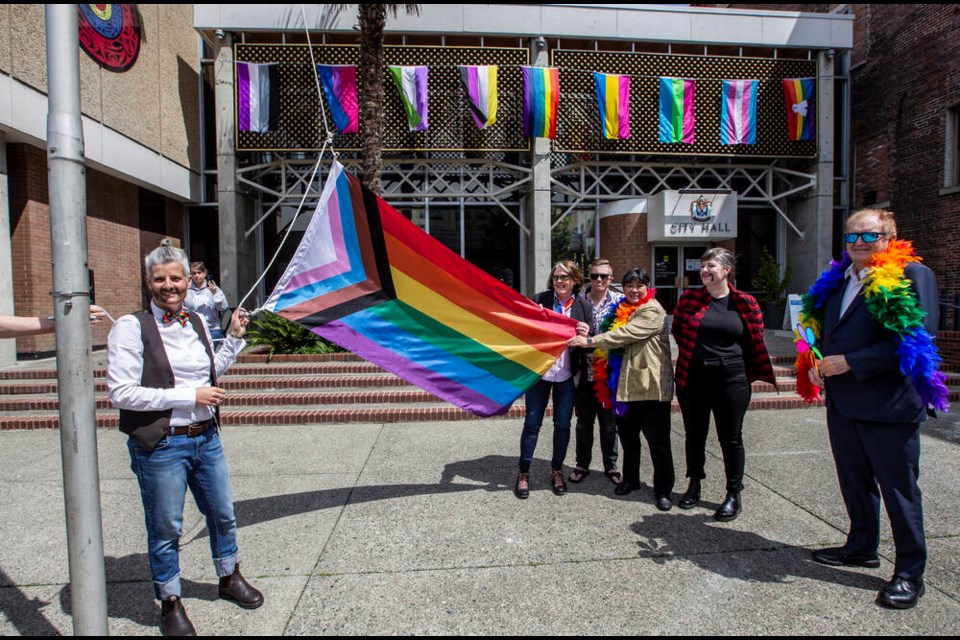 Victoria Mayor Lisa Helps, left, in drag, raises a Pride flag at Victoria City Hall on Friday with, from left, Pride executive director Deidre Rowland, Pride president Britton Kohn, and citycouncillors Charlayne Thornton-Joe, Sarah Potts and Stephen Andrew. The Victoria Pride Festival runs June 23 to July 2, highlighted by the Pride Parade on June 26, The Big Gay Dog Walk andthe Memorial Drag Ball Game. DARREN STONE, TIMES COLONIST. June 17, 2022 