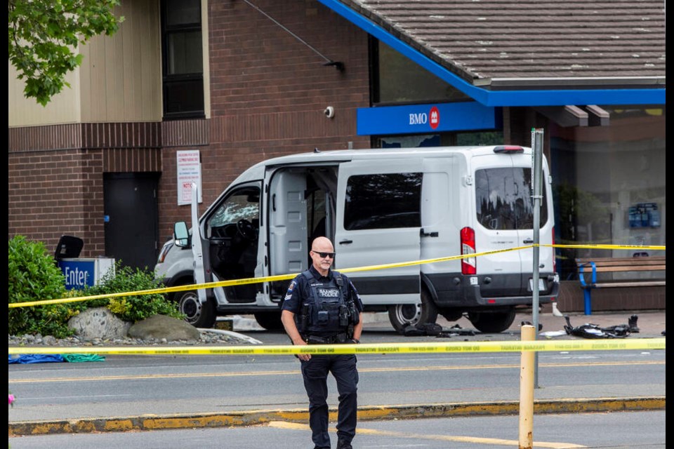 A bullet-riddled Greater Victoria Emergency Response Team van outside the Bank of Montreal branch on Shelbourne Street. DARREN STONE, TIMES COLONIST 