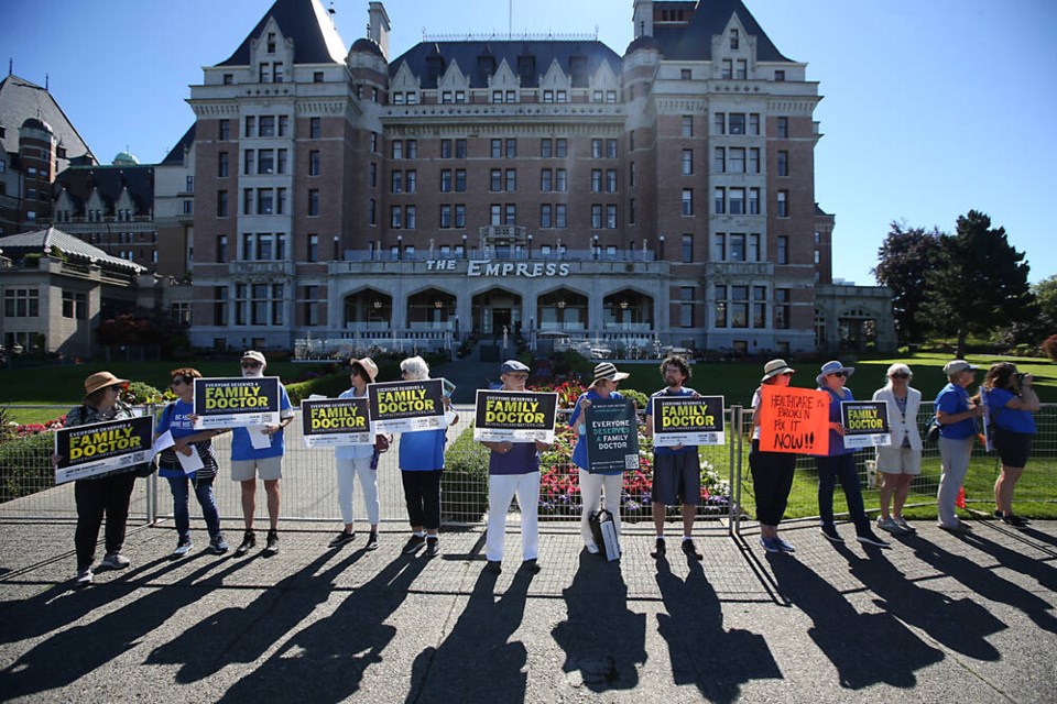 A group calling for more family doctors protests in front of the Empress Hotel on Tuesday as Canadas premiers meet inside. ADRIAN LAM, TIMES COLONIST 