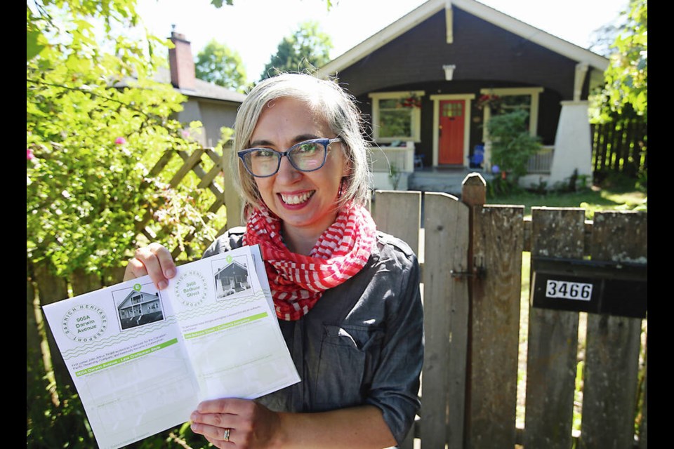 Sonia Nicholson, vice-president of the Saanich Heritage Foundation, with the Saanich Heritage Passport, 
a self-guided walking and cycling tour of heritage structures in Saanich. ADRIAN LAM, TIMES COLONIST 