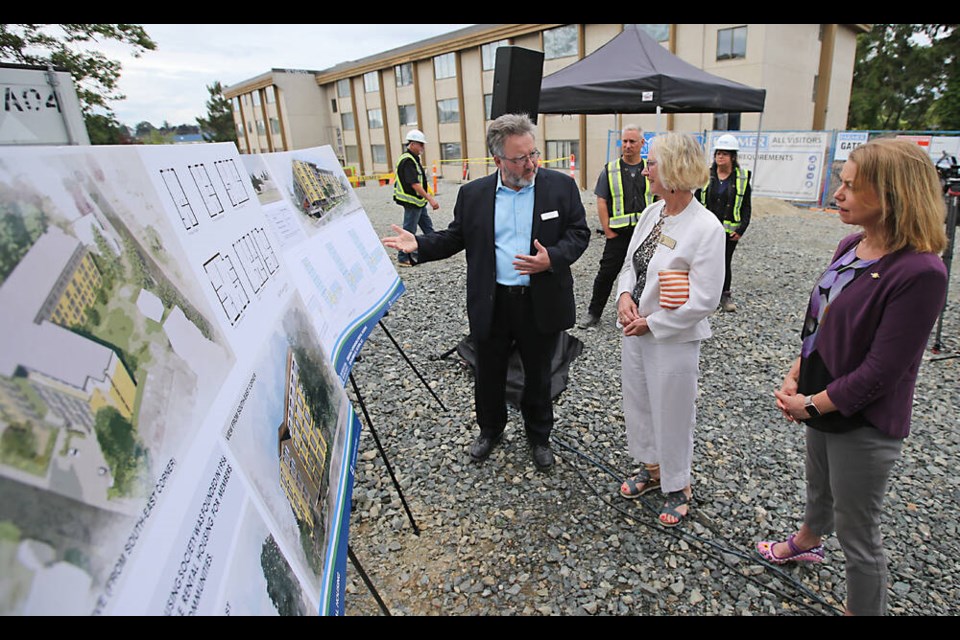 James Munro of the Greater Victoria Housing Society, left, talks with Esquimalt-Metchosin MLA Mitzi Dean, right, and Esquimalt Mayor Barb Desjardins at the launch of construction Wednesday. ADRIAN LAM, TIMES COLONIST 