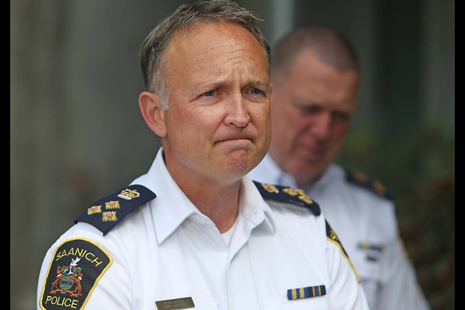 Saanich police Chief Const. Dean Duthie, with deputy chief Gary Schenk, gives an update Tuesday on the officers injured in a shootout at the Bank of Montreal on Shelbourne Street on June 28. ADRIAN LAM, TIMES COLONIST 
