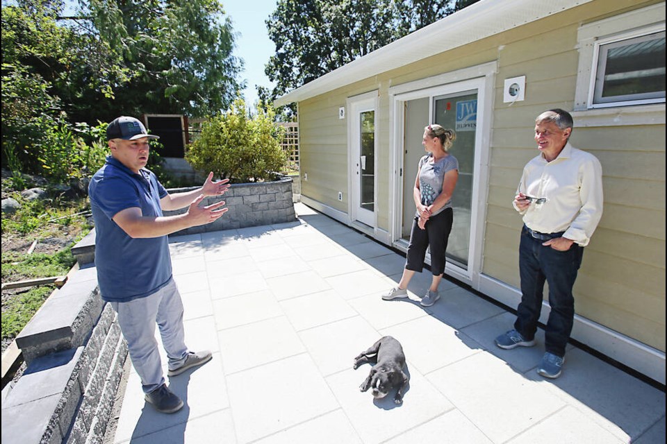 Saanich Mayor Fred Haynes, right, visits a garden suite under construction in the Gorge-Tillicum area with Nick Kardum of Backyard Bungalows, left, and homeowner Lesley Murphy. ADRIAN LAM, TIMES COLONIST 