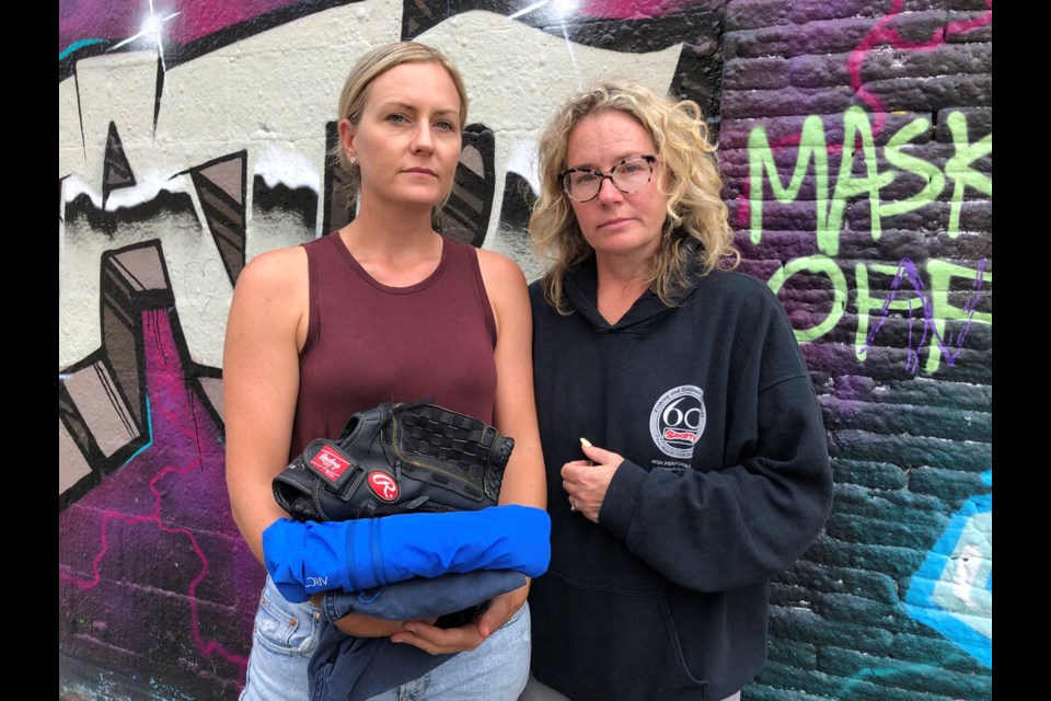 Tammy Trausch, left, and Candice Csaky with some of their brother's belongings, collected from his tent on Pandora Avenue in Victoria. Chris Schwede was found dead of a suspected drug overdose on Thursday. LOUISE DICKSON, TIMES COLONIST 