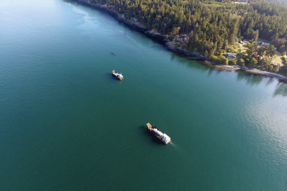Response vessels with vacuum trucks on board are shown off San Juan Island, Washington. U.S. Coast Guard via The Canadian Press 