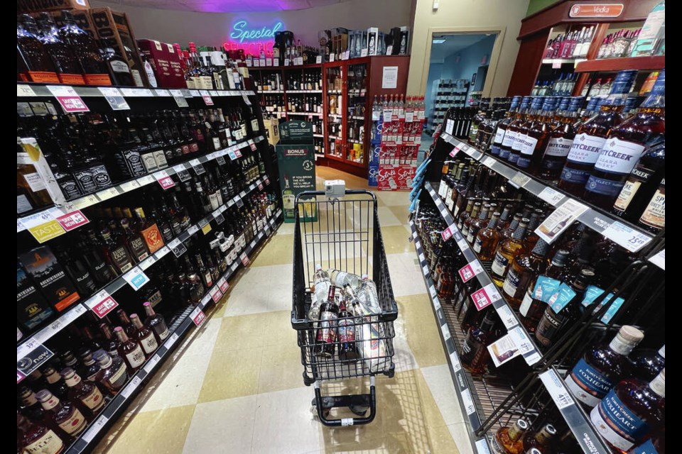 A person's purchases are seen in a shopping cart at a government-run B.C. Liquor Store in Vancouver, on Friday, August 19, 2022. THE CANADIAN PRESS/Darryl Dyck 