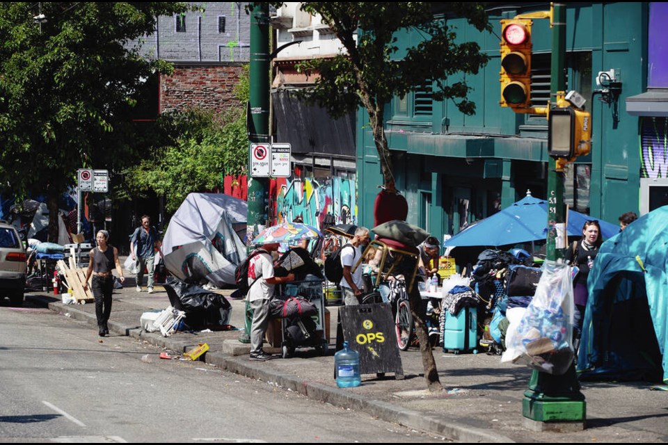 Tents line the sidewalk on East Hastings Street as the city works to clear tents from a sprawling homeless encampment in the Downtown Eastside of Vancouver, on Tuesday, August 9, 2022. People living in a growing street encampment along a busy street in Vancouver’s Downtown Eastside have been handed notices advising that the tents and other structures are about to be removed. The city’s fire chief issued an order last month requiring the tents be cleared because of an extreme fire safety hazard. THE CANADIAN PRESS/Darryl Dyck