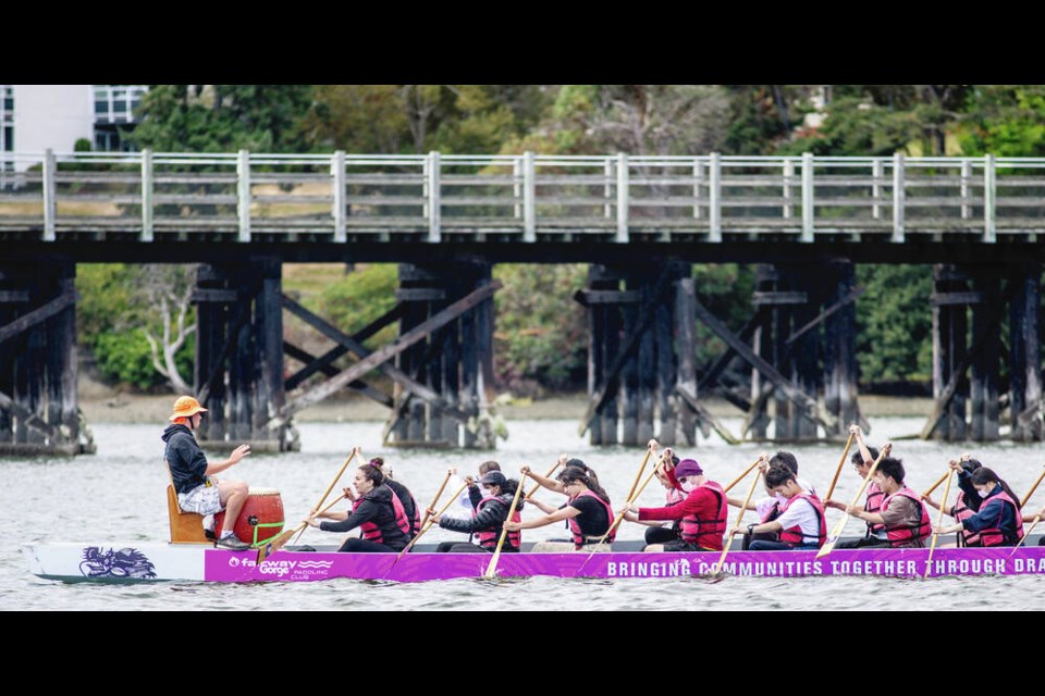 A Fairway Gorge Paddling Club dragon boat moves along the Gorge Waterway on Friday where the Vancouver Island Dragon Boat Festival is taking place this weekend.  DARREN STONE, TIMES COLONIST 